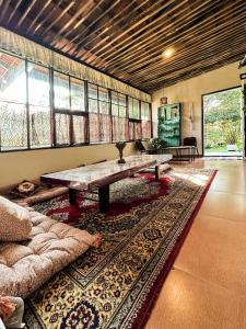 a living room with a table and a couch at Mass Bungalow in Tindummal