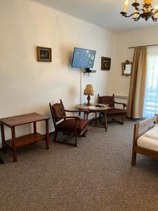 a living room with furniture and a flat screen tv at Katalin vendégház felső szint in Visegrád