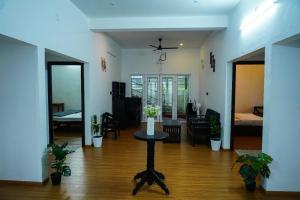 a living room with a table in the middle of a room at Adithya resort vagamon in Vagamon