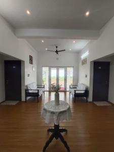 a large living room with a table and chairs at Adithya resort vagamon in Vagamon