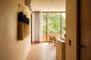 a hallway with a desk and a large window at Aldea Mayab Luxury Residences by Lagoona in Bacalar