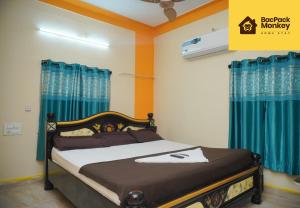 a bedroom with a bed with blue curtains at Zapstays-Homestays in Visakhapatnam