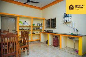 a kitchen with a table and chairs in a room at Zapstays-Homestays in Visakhapatnam