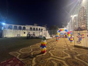 a building with christmas lights and decorations on the ground at Hotel paras in Dera Bassi