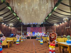 a large tent with tables and chairs and a bear on them at Hotel paras in Dera Bassi +3 photos