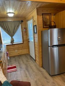 a kitchen with a refrigerator and a window at Ak backcountry retreat in Kenai