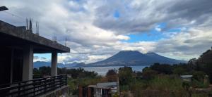 a view of a mountain and a body of water at HOTEL D&S Ch'umil in Tzununá