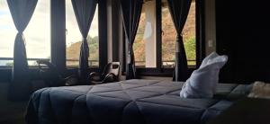 a bedroom with a bed in front of a window at HOTEL D&S Ch'umil in Tzununá +8 photos