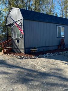 a house with an american flag on the side of it at Ak backcountry retreat in Kenai