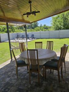 a table and chairs on a patio at Pensiunea Fira in Baia de Fier