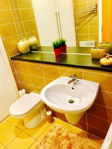 a bathroom with a sink and a toilet at Glasgow City Center Flat with Parking in Glasgow +39 photos