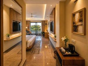 a hotel room with a bed and a desk in it at Aachman Riviera Valley dharamshala by NAINA STAYCATION in Dharmsāla