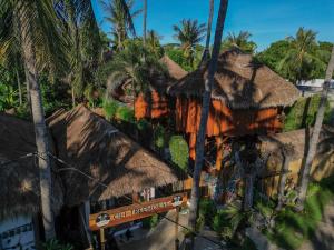 a resort with thatched roofs and palm trees at Gili Treehouses Private Pool Hideaway in Gili Trawangan