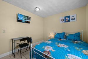 a bedroom with a blue bed and a desk at The Public Street Residence in Providence