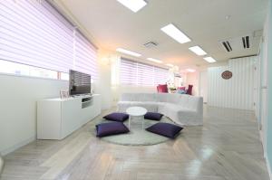 a living room with a couch and a table at Sweet House Umeda Minami in Osaka