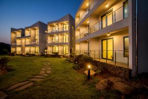 an apartment building at night with a candle in the yard at Poema Stay Pension in Jeju