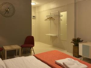 a bedroom with a bed and a chair and a mirror at The Mansion Pakchong in Pak Johng +54 photos