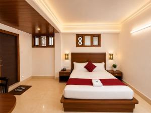 a bedroom with a large bed with red pillows at Gangtok Central Rooms in Gangtok
