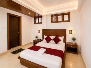 a bedroom with a large bed with red pillows at Gangtok Central Rooms in Gangtok +3 photos