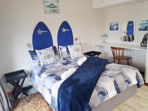 a bedroom with a bed with surfboards on the wall at The Deck in Jeffreys Bay