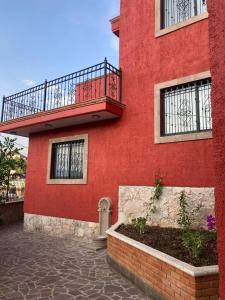 a red building with a balcony on the side of it at Casa Granada in Guanajuato