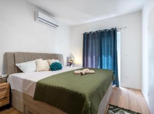 a bedroom with a bed with two towels on it at Villa Peace Oasis in Lovreć +42 photos