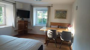 a bedroom with a table and two chairs and a bed at Ferienwohnung Sofka in Sekull