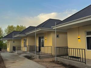 a row of houses with yellow and black roofs at Tosor Guest House Medet in Tossor
