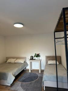 a bedroom with two bunk beds and a table at Tosor Guest House Medet in Tossor