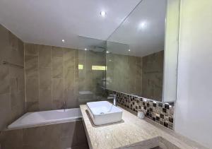 a bathroom with a tub and a sink and a shower at Sea-view apartment in Azur in Ban Tai