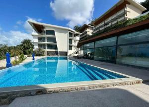 a swimming pool in front of a building at Sea-view apartment in Azur in Ban Tai