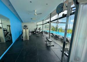 a gym with a view of a swimming pool at Sea-view apartment in Azur in Ban Tai
