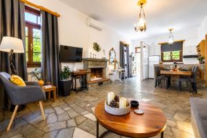 a living room with a couch and a table at Efcharis house Skopelos in Neo Klima