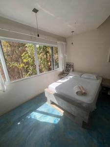 a bedroom with a bed and a large window at Casa Nisadó in San Agustinillo