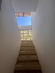 a staircase leading up to a window in a building at Casa Nisadó in San Agustinillo