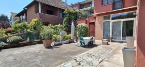 a patio in front of a house with a table at La Casa di Anastasya in Castiglione Torinese