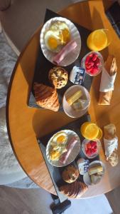 a table with plates of breakfast foods on it at Le cocoon de choupette in Cuvilly +13 photos