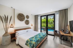 a bedroom with a bed and a desk and a television at Ayurvedagram Bali - Wellness & Retreat Resort in Ubud +44 photos