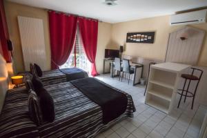 a hotel room with two beds and a kitchen at Hotel Médicis in Roussillon en Isere