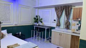 a room with a bed and a desk in it at The Glory Apartment 3 in Imphal
