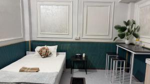 a bedroom with a bed and a green wall at The Glory Apartment 3 in Imphal