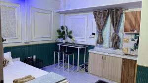 a room with a bed and a table and a window at The Glory Apartment 3 in Imphal