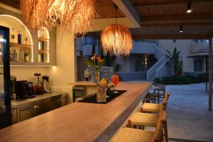 a kitchen with a long wooden table and chairs at Villaggio Mare Suites in Kalamaki