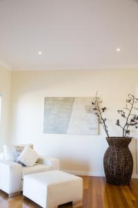 a living room with a couch and a vase at The Edge in Robe