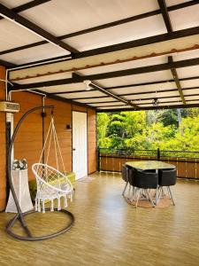 a room with a ping pong table and a swing at SABAYA HOMESTAY in Balik Pulau