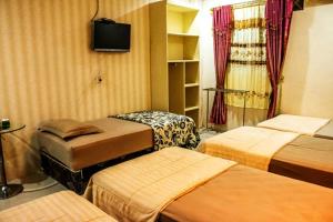 Postel nebo postele na pokoji v ubytování Hotel Alifa Syariah + 23 fotografií