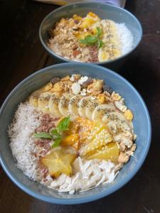 two bowls of food with bananas on top of rice at Anya's Loft - Sky Stay in Mirissa