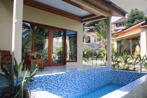 a house with a swimming pool in the yard at The Garden Sanctuary Homestay in Sidemen