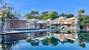 a house with a swimming pool in front of it at Siquijor Jade ocean resort in Siquijor