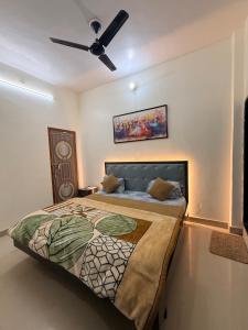 a bedroom with a bed with a ceiling fan at Devansh Palace Near Ram Mandir in Ayodhya